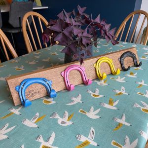 4 horseshoe hooks on oak board
